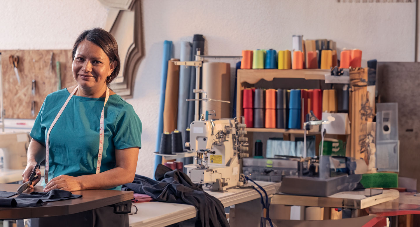 Beautiful woman working in the tailoring industry poses in front of the camera for a portrait.