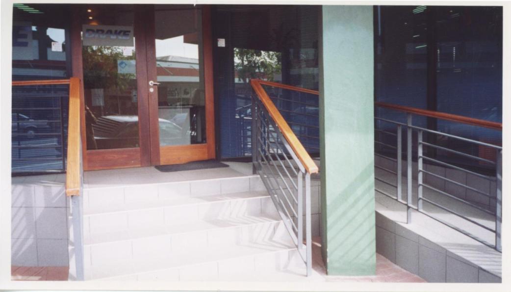 Non-compliant ramp entrance - no landing space left when doors open onto it