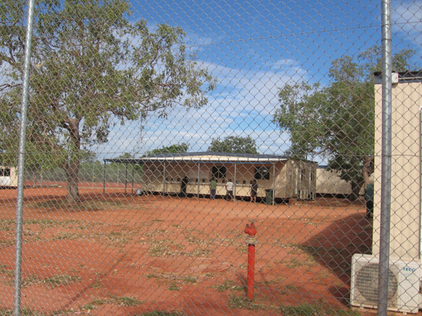 People in detention using outdoor telephones, Curtin IDC