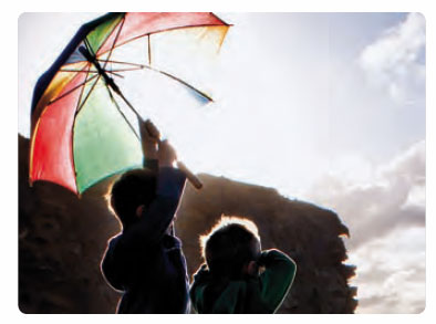 two boys with an umbrella. (c) Naomi Frost