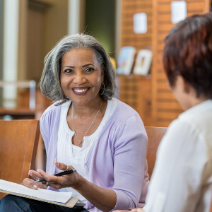 A senior lady at work in a meeting with 2 other females