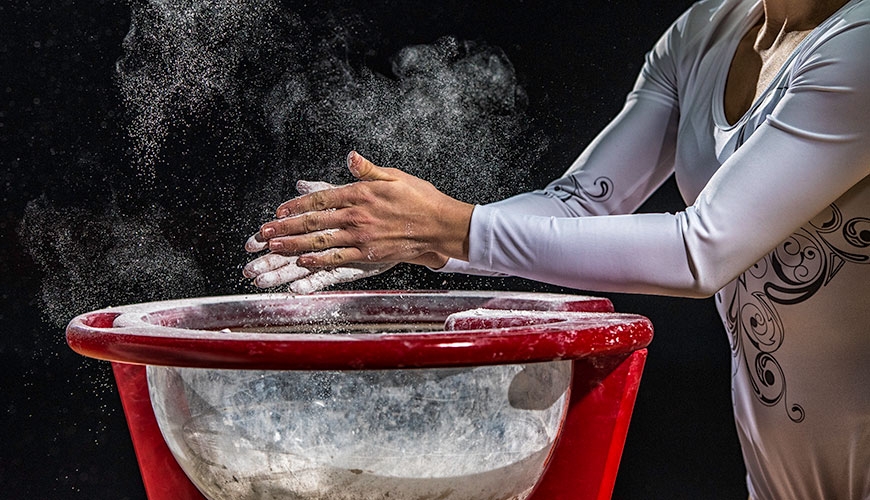 Gymnast applying chalk