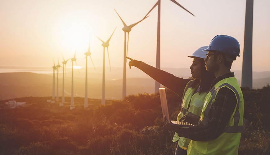 Workers looking at wind turbines