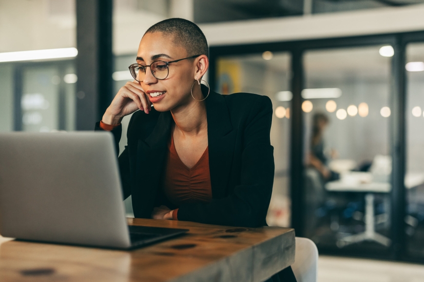 Business woman attending a virtual meeting in an office.