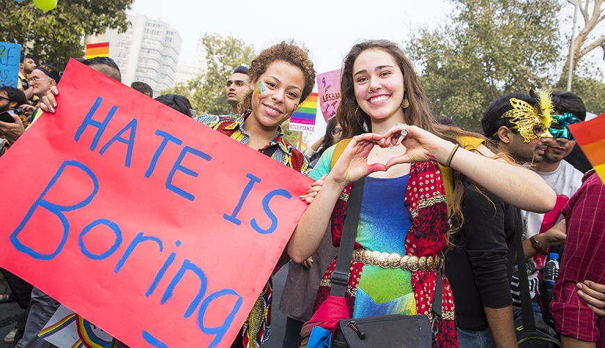 Pride parade with sign 'Hate is boring'