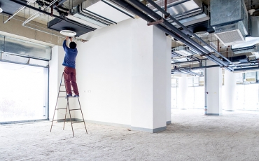 worker on ladder in construction site