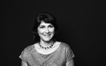 A black and white photograph of a smiling woman with dark hair Sex Discrimination Commissioner Dr Anna Cody.