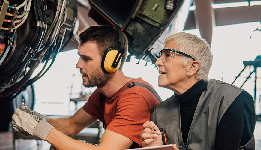 man and woman working on an aircraft