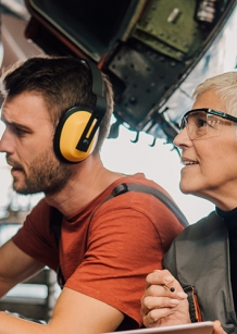 man and woman working on an aircraft