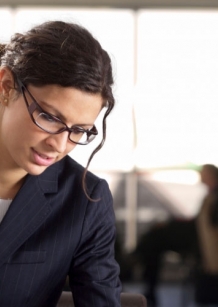 Woman looking down at her work in office setting