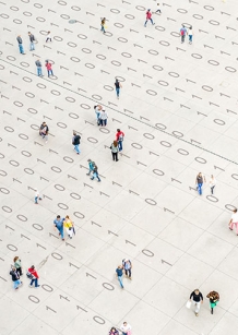 crowd walking over binary code