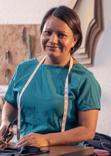 Beautiful woman working in the tailoring industry poses in front of the camera for a portrait.