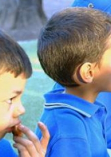 Young children eating lunch in their uniform