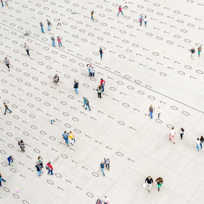 crowd walking over binary code