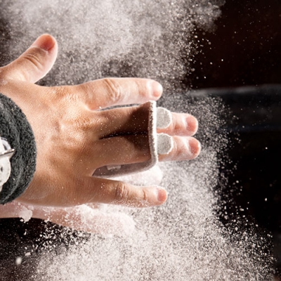 Gymnast applying chalk