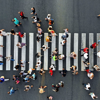 Street crossing scene from above, several dozen people crossing