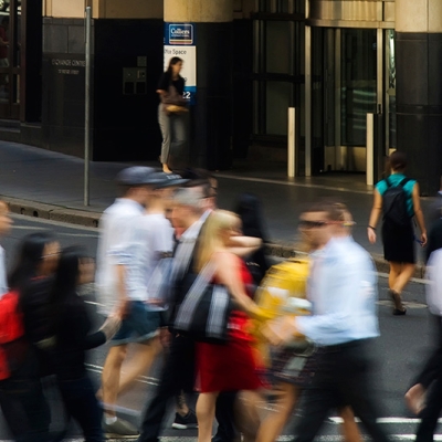 Bustling city street with people crossing the road